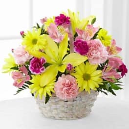 Basket of yellow daisies and pink flowers