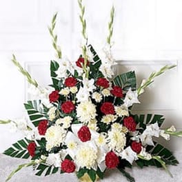 Red and white floral standing spray with tall white spikes