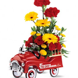 Red toy truck filled with red and yellow flowers