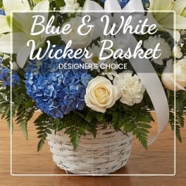 Blue and white flower basket in a white wicker basket with ribbon