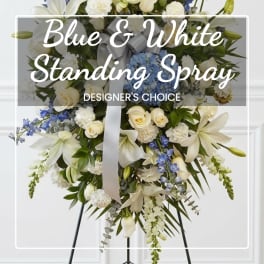 Blue and white standing spray with lilies and roses on an easel