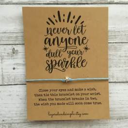 A kraft card with a wish bracelet and inspirational text