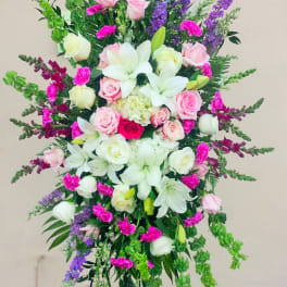 Tall standing floral spray with pink roses, white lilies, and purple spikes