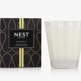 Scented candle in a frosted glass tumbler beside its box