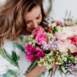 Woman holding a bouquet of pink and white roses