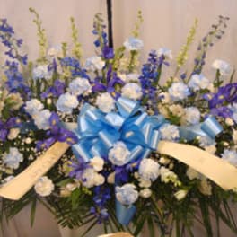 Large blue and white floral spray with ribbon bow