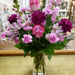 Pink and purple mixed bouquet in a clear glass vase