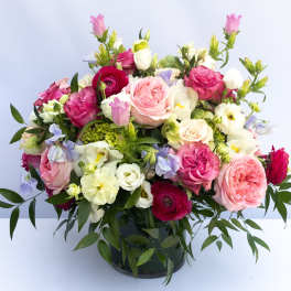 Mixed pink and white bouquet in a dark glass vase