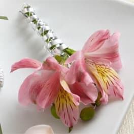 Pink alstroemeria flowers with a silver ribbon-wrapped stem