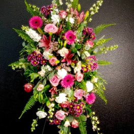 Tall floral spray with pink roses, gerbera daisies, lilies, and white blooms