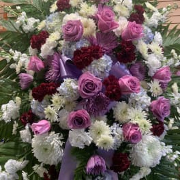 Large standing spray of pink roses, white chrysanthemums, and purple ribbon