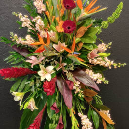 Large tropical floral spray with orange birds of paradise and red gerberas