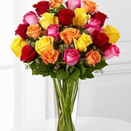 Bouquet of multicolored roses in a clear glass vase