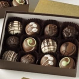Box of assorted decorated chocolates in paper cups