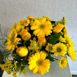 Yellow bouquet with gerbera daisies, roses, and small pom flowers