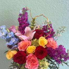 Mixed bouquet with roses, lilies, and purple flowers