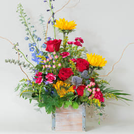 Colorful mixed flower arrangement in a wooden box