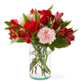 Red and pink mixed bouquet in a clear glass vase