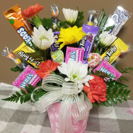 Candy bouquet with faux flowers in a pink pot and ribbon