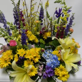 Large mixed bouquet with yellow lilies, daisies, and blue flowers
