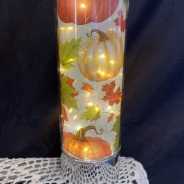 Tall glass candle holder with pumpkin and autumn leaf design