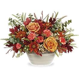Autumn floral arrangement in a white ceramic bowl