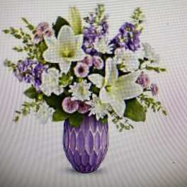 Purple and white floral arrangement in a purple vase