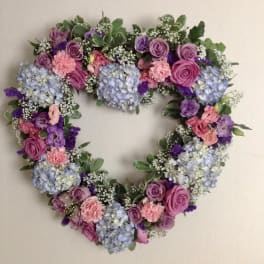 Heart-shaped floral wreath with pink, purple, and blue flowers