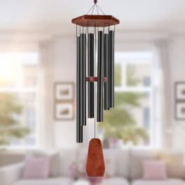 Black wind chime with a wooden top and red clapper