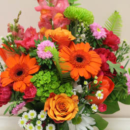 Bright mixed bouquet with orange gerbera daisies and roses