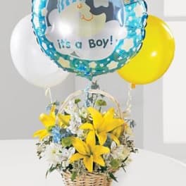 Basket of yellow lilies with a baby boy balloon and two round balloons