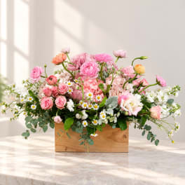 Pink and white mixed flower arrangement in a wooden box