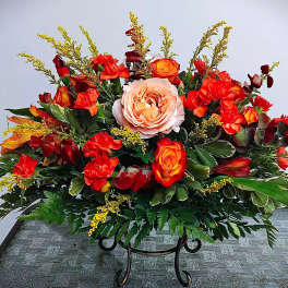 Large arrangement of red and orange roses with a pale peach rose center
