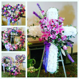 Heart-shaped floral wreath on an easel with pink and purple flowers