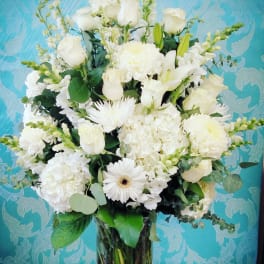 White floral arrangement in a clear glass vase