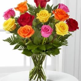 Bouquet of multicolored roses in a clear glass vase