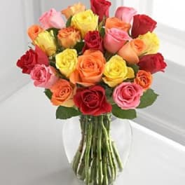 Bouquet of multicolored roses in a clear glass vase
