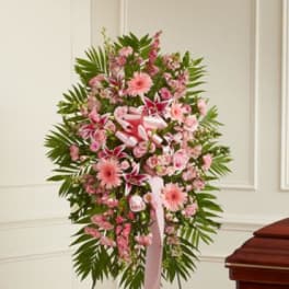 Pink floral standing spray with ribbon on an easel