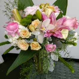 Pink and cream mixed bouquet in a glass vase