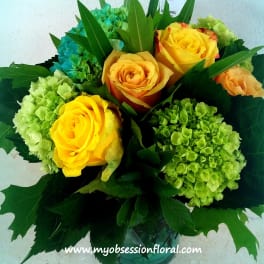 Bouquet of yellow roses and green hydrangeas in a vase