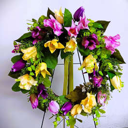 Heart-shaped floral wreath with pink, purple, and yellow blooms