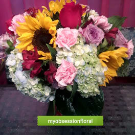 Mixed bouquet with sunflowers, roses, hydrangeas, and carnations