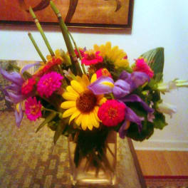 Bright mixed bouquet with yellow daisies, pink blooms, and purple flowers