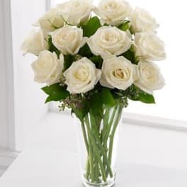 White rose bouquet in a clear glass vase