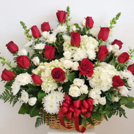 Basket arrangement of red and white roses with white chrysanthemums