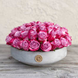 Round box filled with pink roses