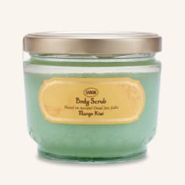 Jar of green body scrub with a gold lid