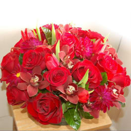 Red roses and pink orchids in a compact bouquet