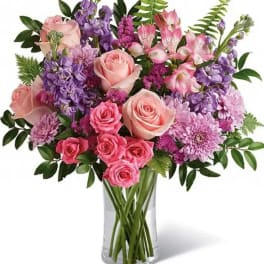 Pink and purple mixed bouquet in a clear glass vase