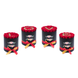 Four round boxes of red roses with ribbon bows